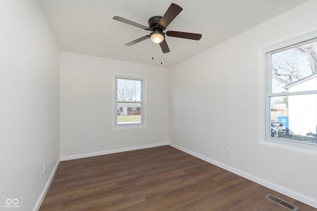 unfurnished room featuring ceiling fan, dark hardwood / wood-style flooring, and a textured ceiling