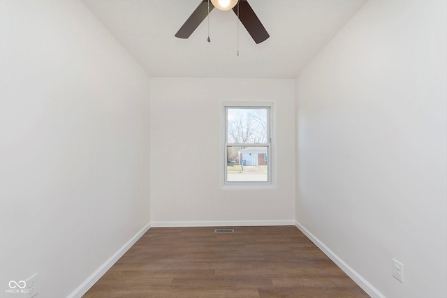 empty room with ceiling fan and dark wood-type flooring