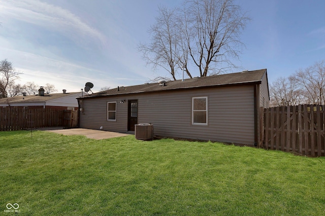 back of house featuring a yard, a patio, and central air condition unit