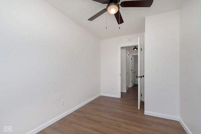 unfurnished room featuring ceiling fan and dark hardwood / wood-style floors