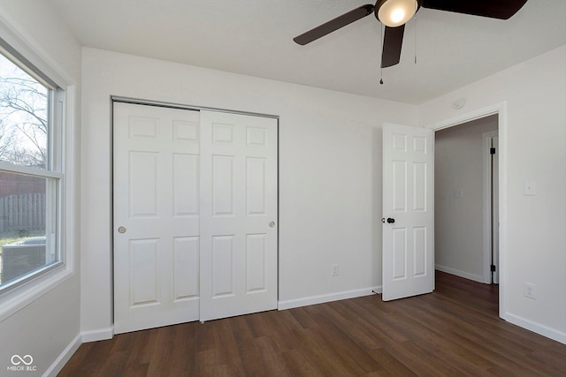 unfurnished bedroom featuring a closet, ceiling fan, and dark wood-type flooring