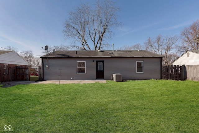 rear view of house with a yard, a patio area, and central air condition unit