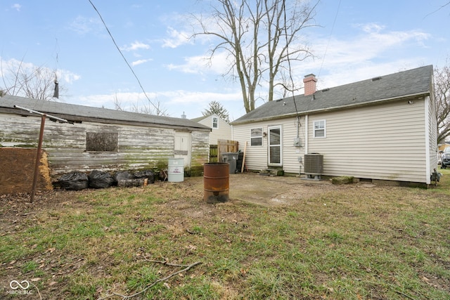 back of house featuring central AC, a yard, and a patio