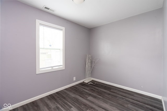 unfurnished room with dark hardwood / wood-style flooring