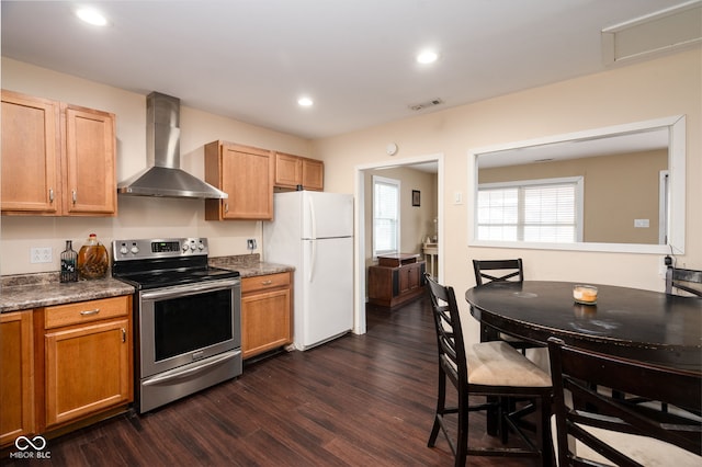 kitchen featuring wall chimney range hood, dark hardwood / wood-style flooring, white fridge, and stainless steel electric range