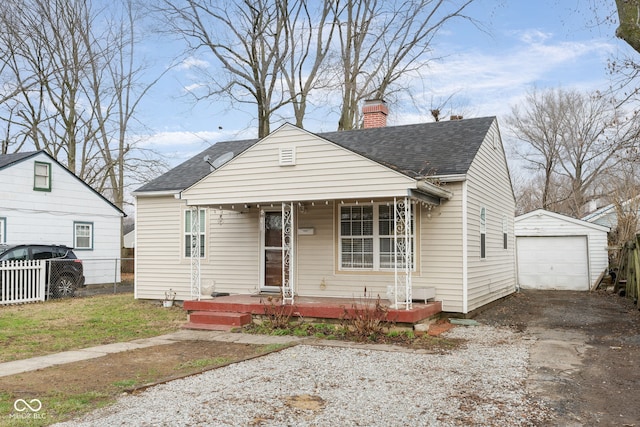 bungalow-style home featuring covered porch, an outdoor structure, and a garage