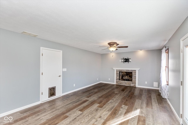 unfurnished living room with hardwood / wood-style flooring and ceiling fan