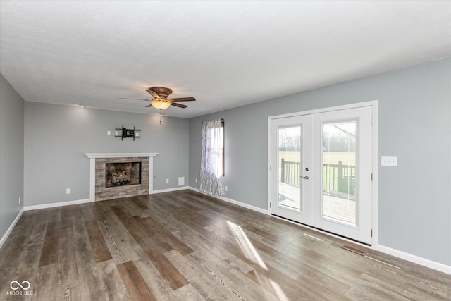 unfurnished living room with ceiling fan, french doors, a textured ceiling, and hardwood / wood-style flooring