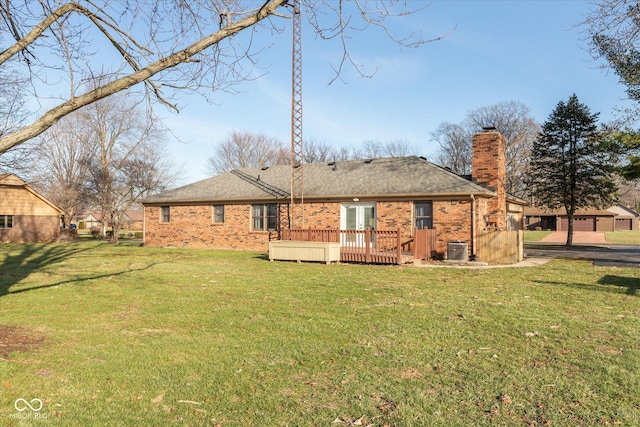 rear view of property with a yard, cooling unit, and a deck