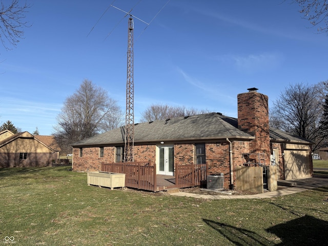 rear view of house with a yard and a wooden deck