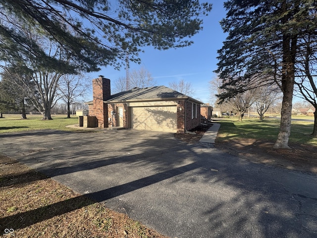 view of side of property featuring a yard and a garage