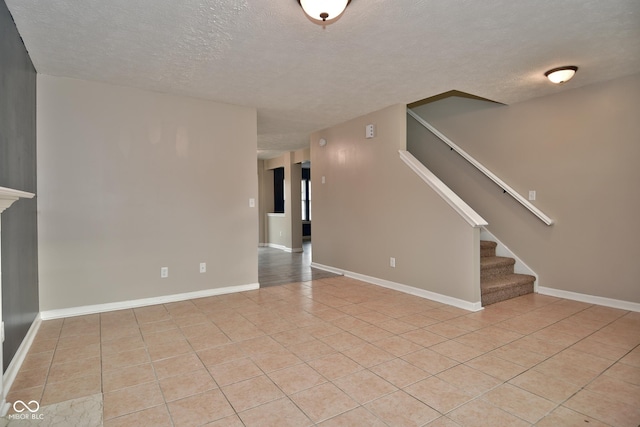 tiled spare room with a textured ceiling