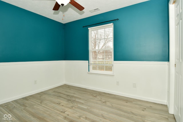 empty room featuring ceiling fan and light hardwood / wood-style flooring