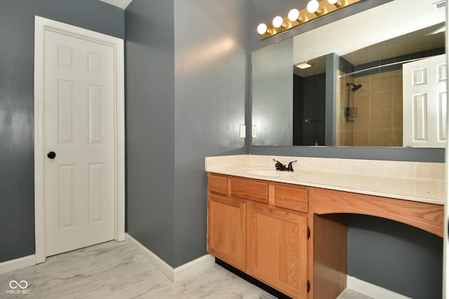 bathroom with vanity and tiled shower