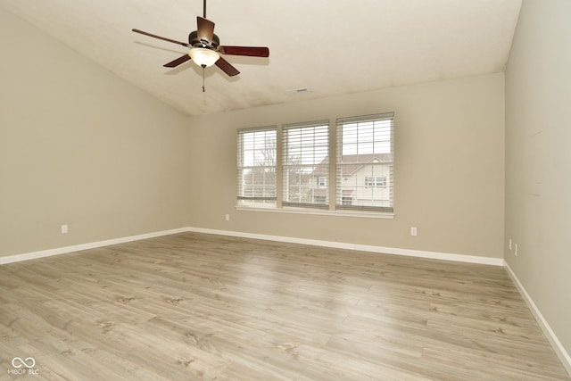 spare room with light hardwood / wood-style flooring, ceiling fan, and lofted ceiling