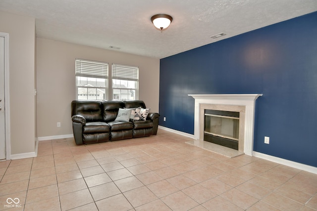 living room featuring light tile patterned floors, a textured ceiling, and a premium fireplace