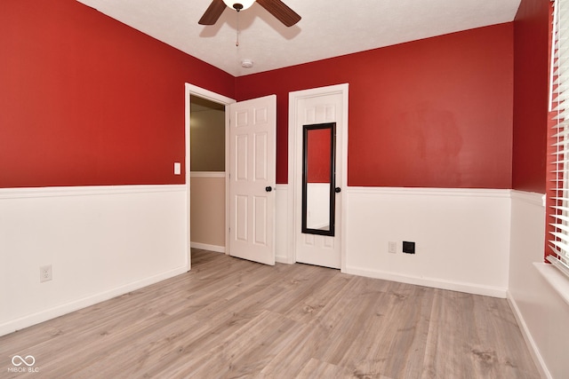 empty room with light hardwood / wood-style flooring and ceiling fan