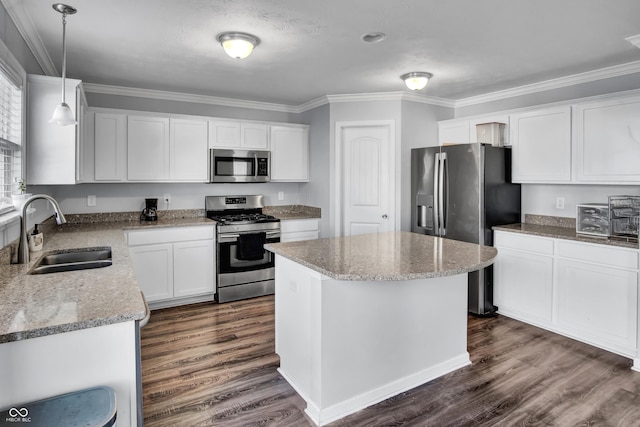 kitchen with white cabinetry, a center island, sink, hanging light fixtures, and stainless steel appliances