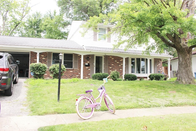 single story home with a front yard, a garage, and covered porch