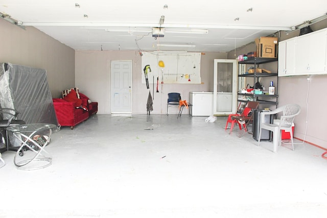 garage featuring a garage door opener and washer / dryer