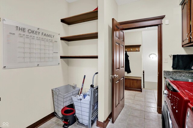 3592 W Smokey Row Rd, Bargersville, IN 46106 - laundry room featuring cabinet space, washing machine and clothes dryer, and light tile patterned floors