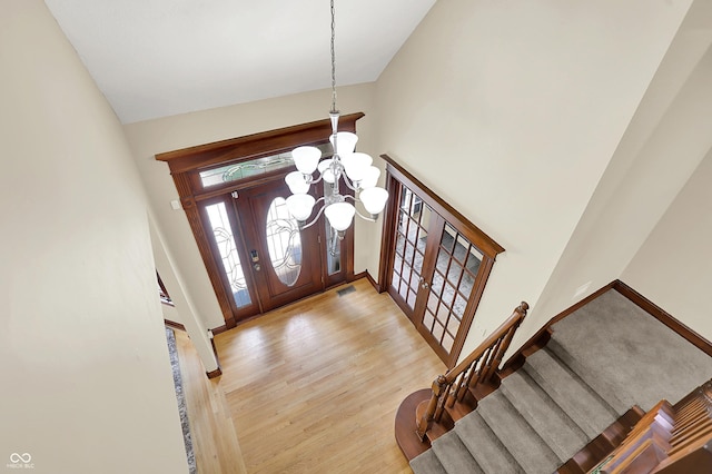 3592 W Smokey Row Rd, Bargersville, IN 46106 - foyer with high vaulted ceiling, stairway, a chandelier, wood finished floors, and french doors