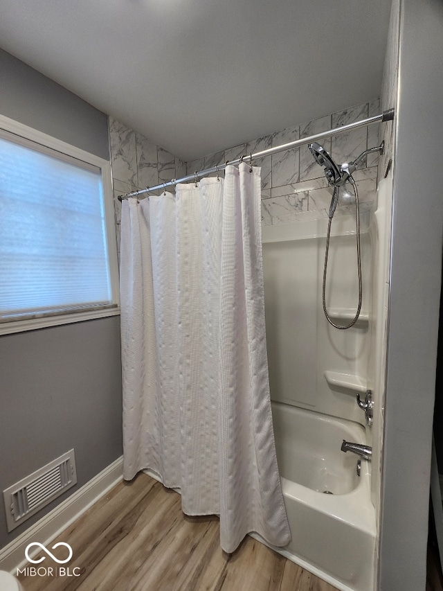 bathroom featuring shower / tub combo and hardwood / wood-style flooring