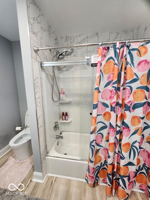 bathroom with shower / tub combo, toilet, and hardwood / wood-style floors