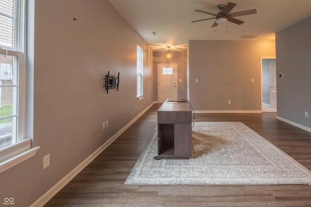 interior space featuring baseboards, visible vents, and dark wood finished floors