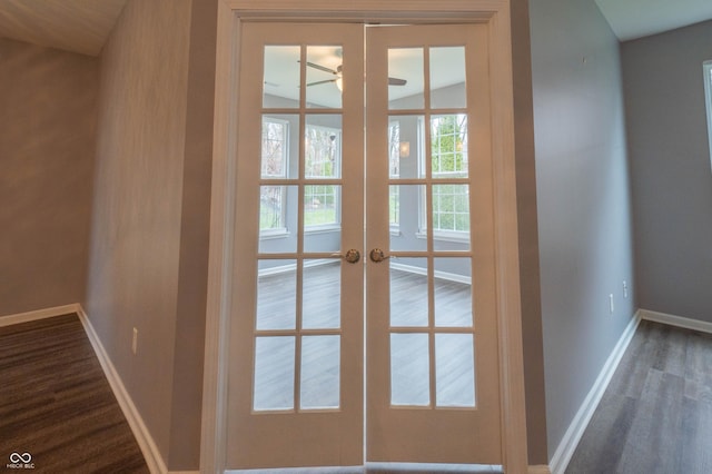 doorway to outside with baseboards, dark wood finished floors, a ceiling fan, and french doors