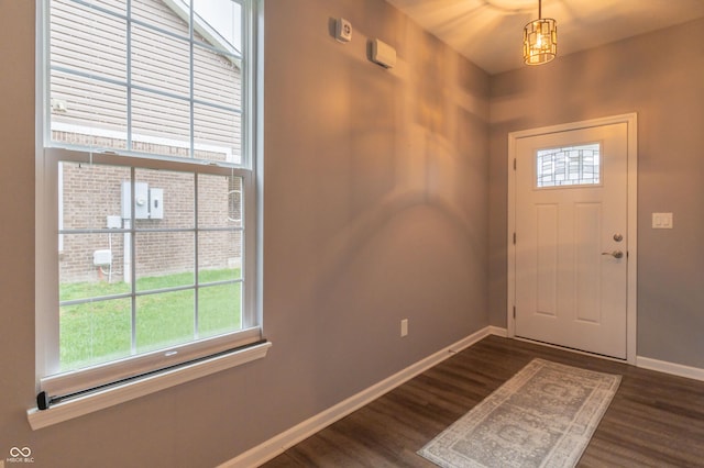 entrance foyer with dark wood finished floors and baseboards