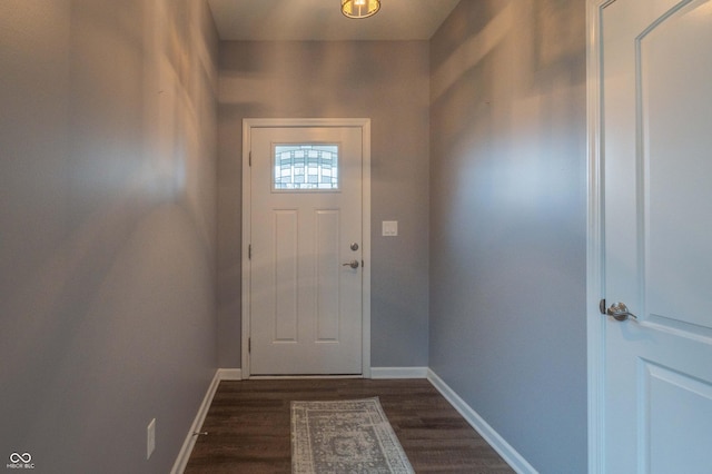 doorway featuring baseboards and dark wood finished floors