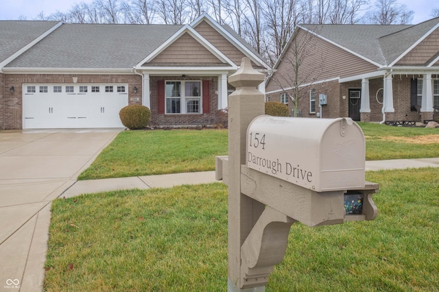 details with a downspout, concrete driveway, and brick siding