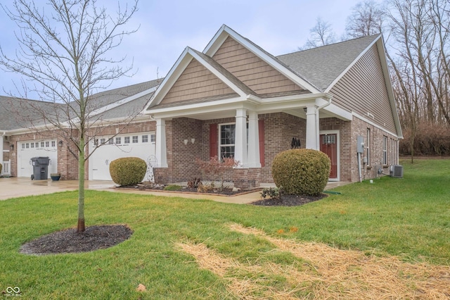 craftsman inspired home with brick siding, an attached garage, cooling unit, driveway, and a front lawn