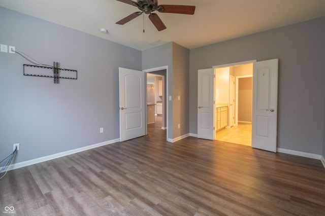 unfurnished bedroom with a ceiling fan, baseboards, and wood finished floors