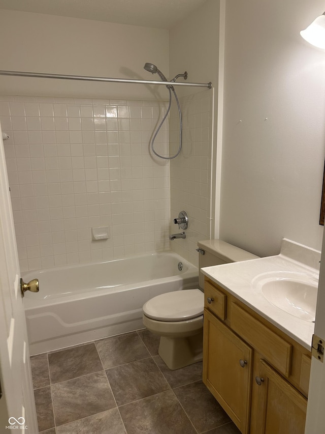 full bathroom featuring vanity, toilet, and tiled shower / bath