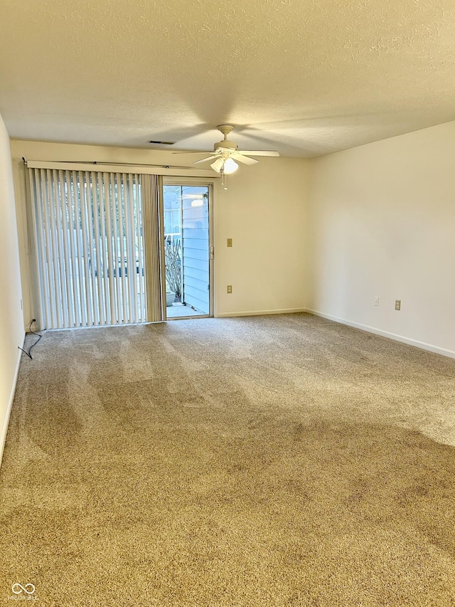 empty room featuring carpet and a textured ceiling