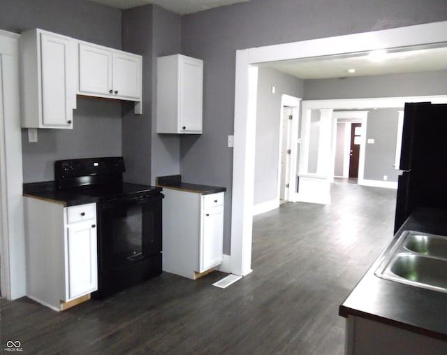 kitchen with white cabinets, electric range, refrigerator, and sink