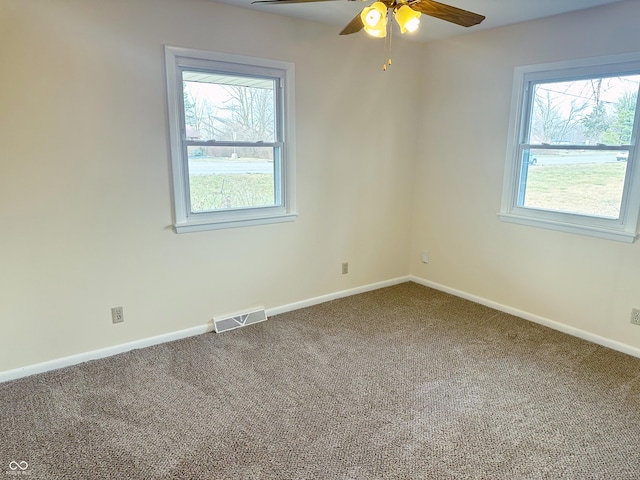 spare room featuring carpet flooring and ceiling fan