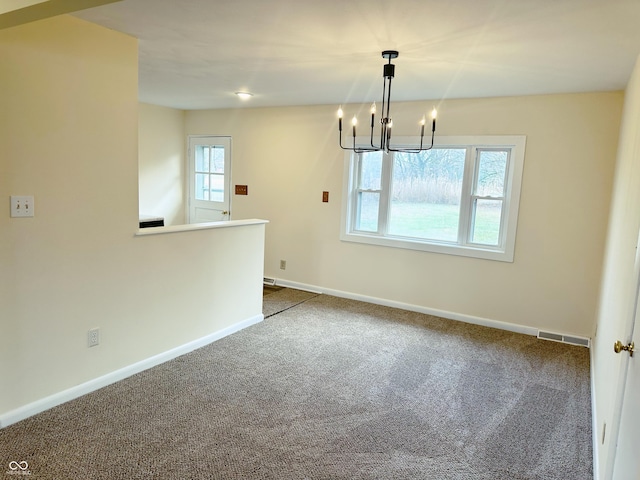 interior space featuring a wealth of natural light, carpet, and a notable chandelier