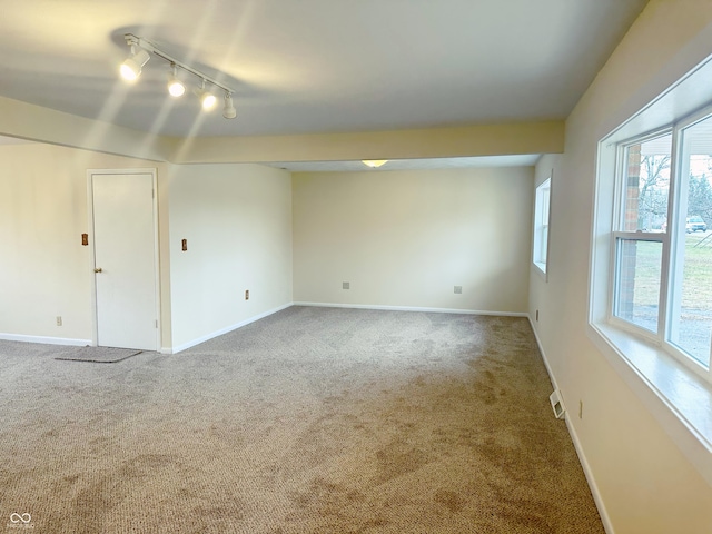 unfurnished room with carpet flooring and track lighting