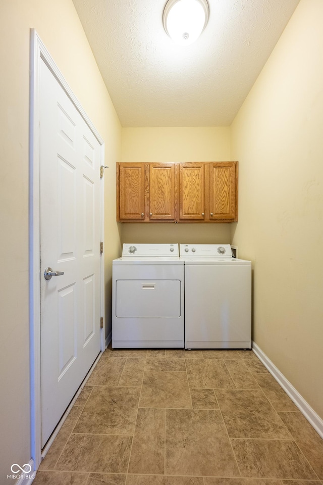 laundry room featuring independent washer and dryer and cabinets