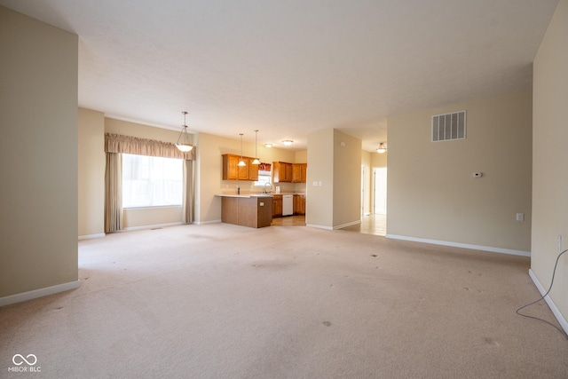 unfurnished living room with sink and light colored carpet