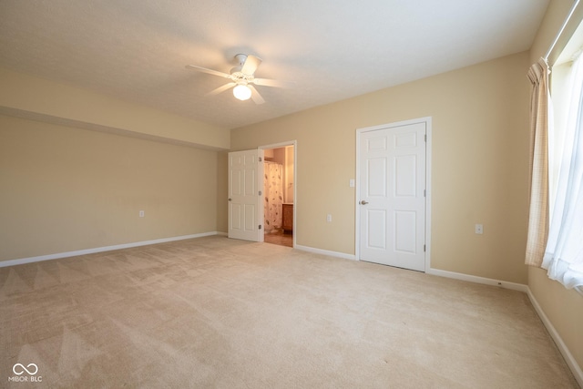 unfurnished bedroom featuring light colored carpet and ceiling fan