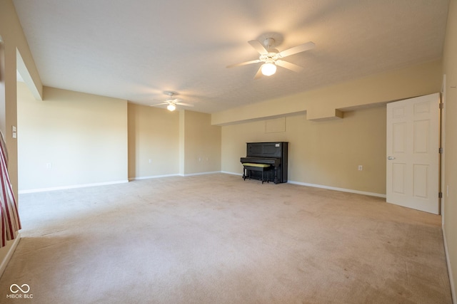 unfurnished living room featuring light colored carpet and ceiling fan