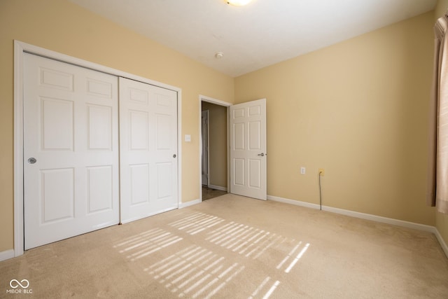 unfurnished bedroom featuring carpet and a closet