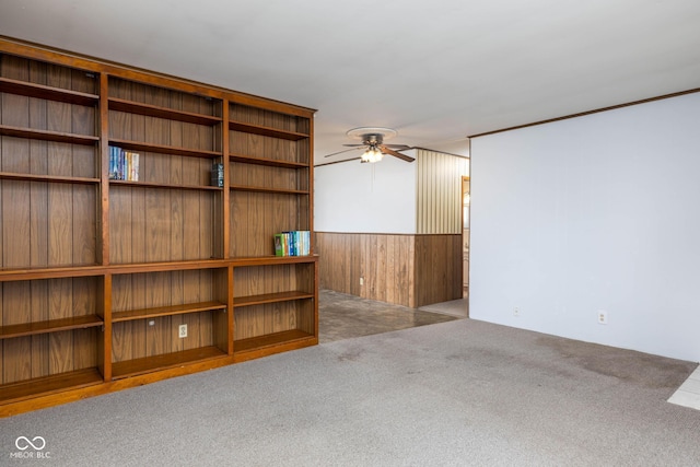 unfurnished living room featuring ceiling fan and light colored carpet