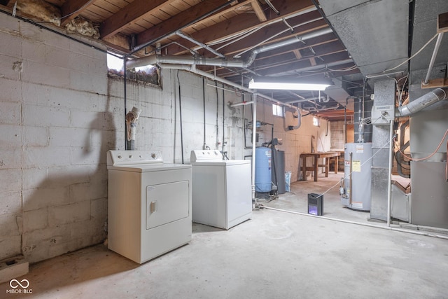 basement with water heater and washer and dryer