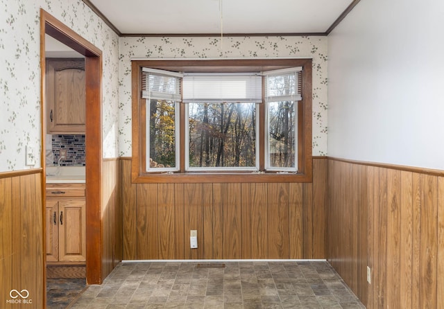 unfurnished room featuring crown molding