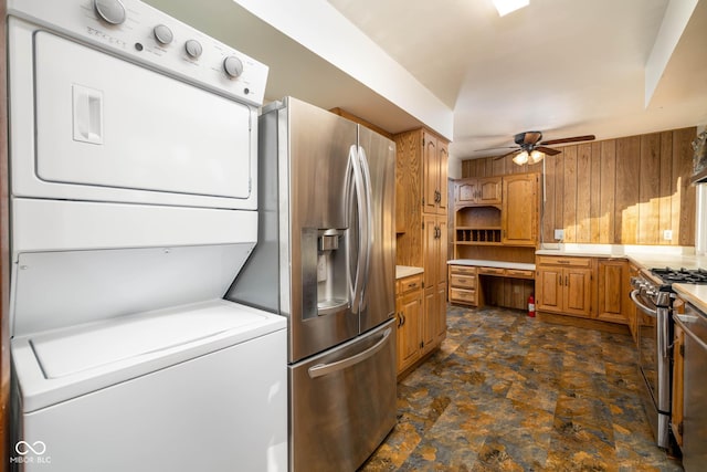 kitchen featuring stacked washer / drying machine, ceiling fan, and appliances with stainless steel finishes